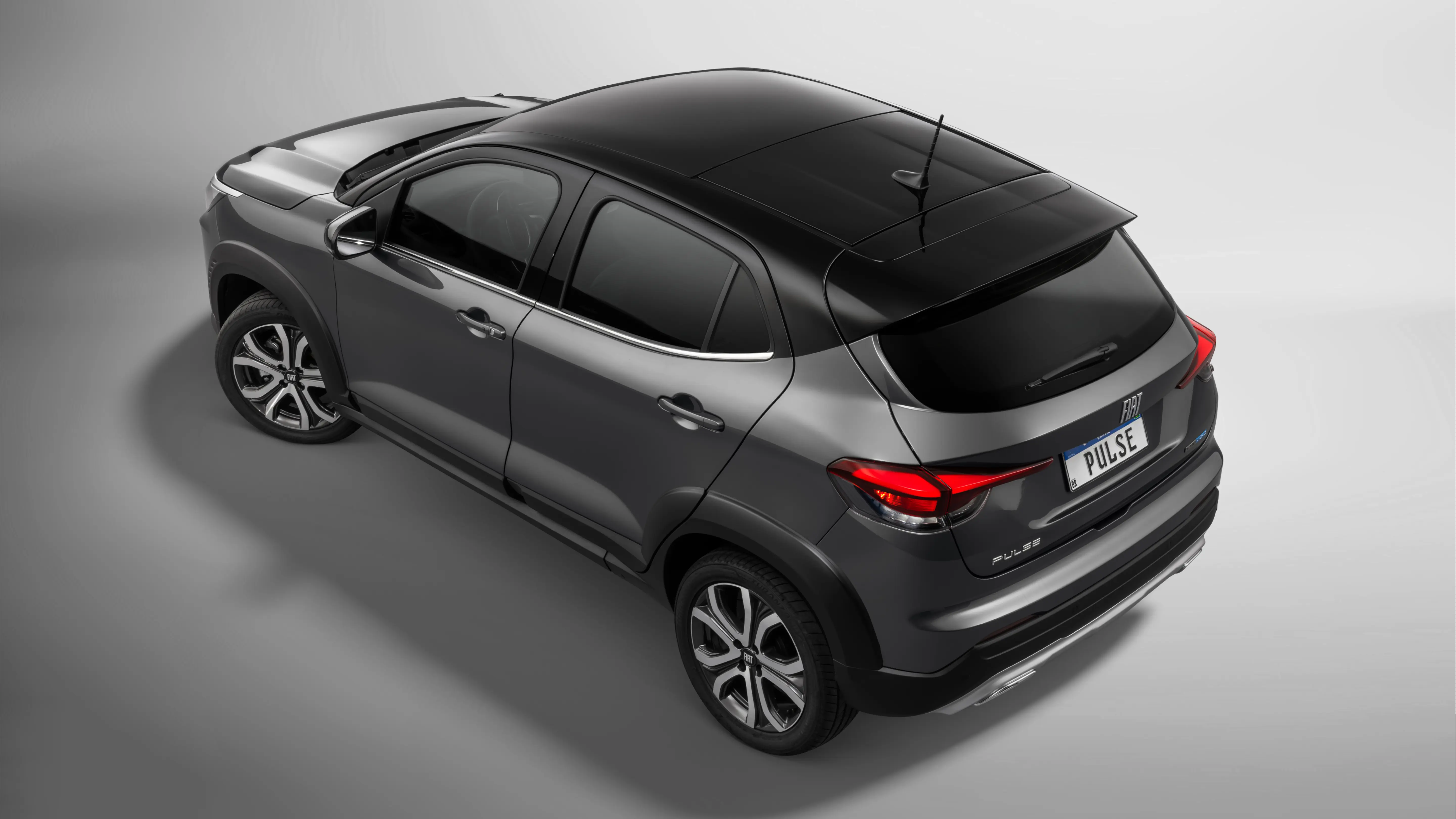 Vista superior de Fiat Pulse na cor preta, com destaque para teto solar panorâmico, que permite a visão interna do carro, mesmo fechado